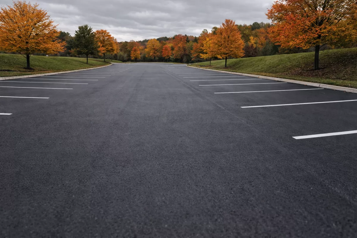Commercial asphalt surface with protective sealed finish in autumn, free of debris and damage, anonymous setting