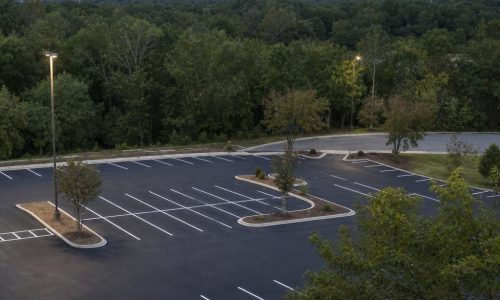 Freshly striped parking lot on a gentle, wooded slope in Macon, Georgia.